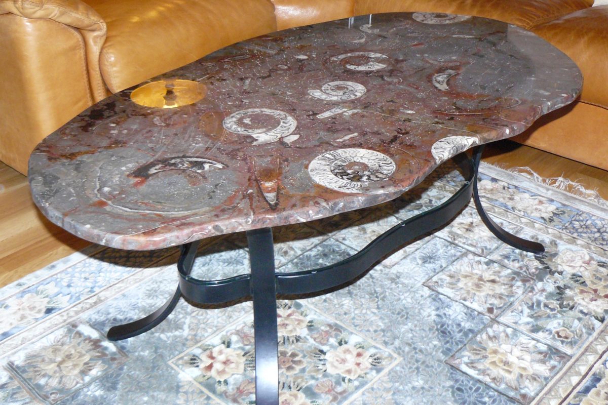 Table irrégulière en pierre d'Erfoud macrofossiles et son socle en fer de forme irrégulière